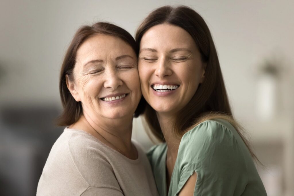 Partial Dentures In Trinity: A Flexible, Budget-Friendly Way To Complete Your Smile Smiling mother and daughter with closed eyes and heads touching.