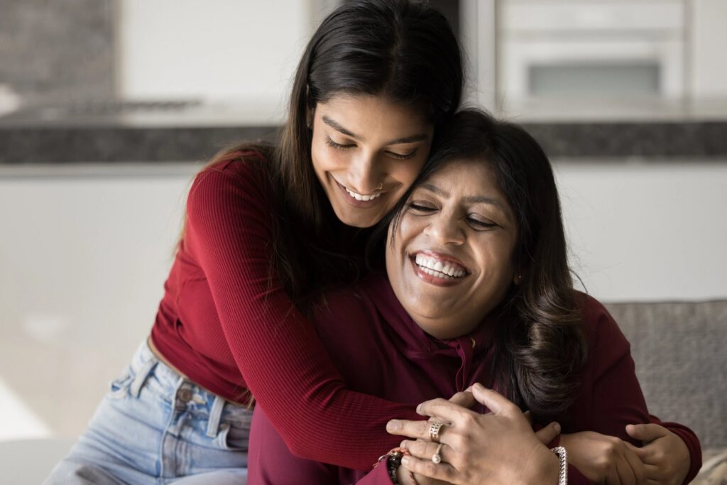 Happy mother and daughter hugging.